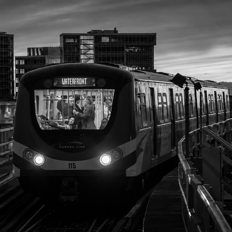 Canada Line SkyTrain arriving at Richmond station, representing the city's modern public transit and urban connectivity.