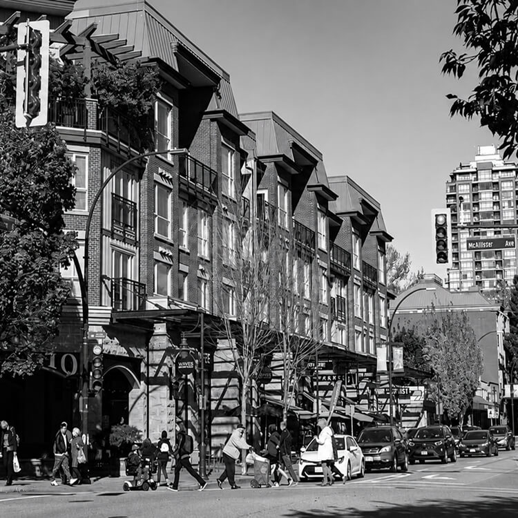 Street view of Coquitlam City Centre featuring mixed-use buildings, local businesses, pedestrians, and everyday urban activity.
