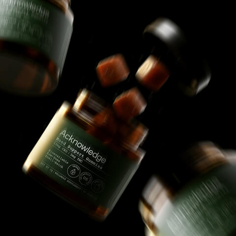 Branded cannabis wellness products captured in a dynamic product photography composition.
