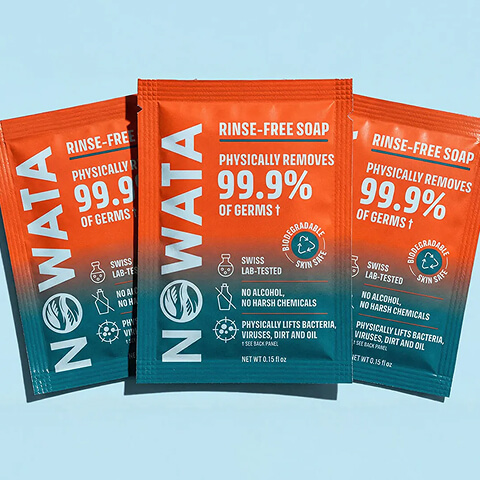 Three NOWATA rinse-free soap packets featuring orange and teal packaging and product benefit information.