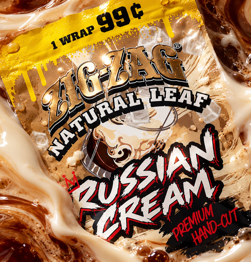 Close-up of Zig-Zag Natural Leaf Russian Cream packaging surrounded by swirling cream, coffee, and ice-inspired elements.
