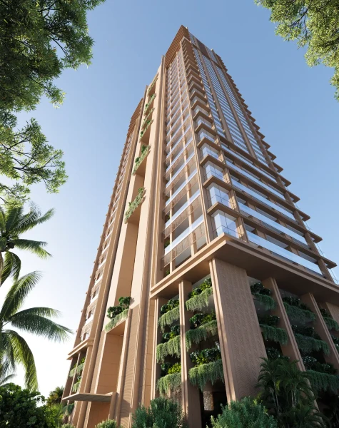 Modern tall residential building with glass balconies and vertical greenery, viewed from below against a clear blue sky.