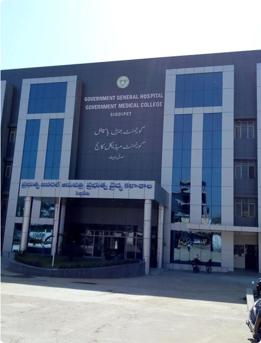 Front entrance of Government General Hospital and Government Medical College building in Siddipet with large glass windows and signage in English, Urdu, and Telugu.