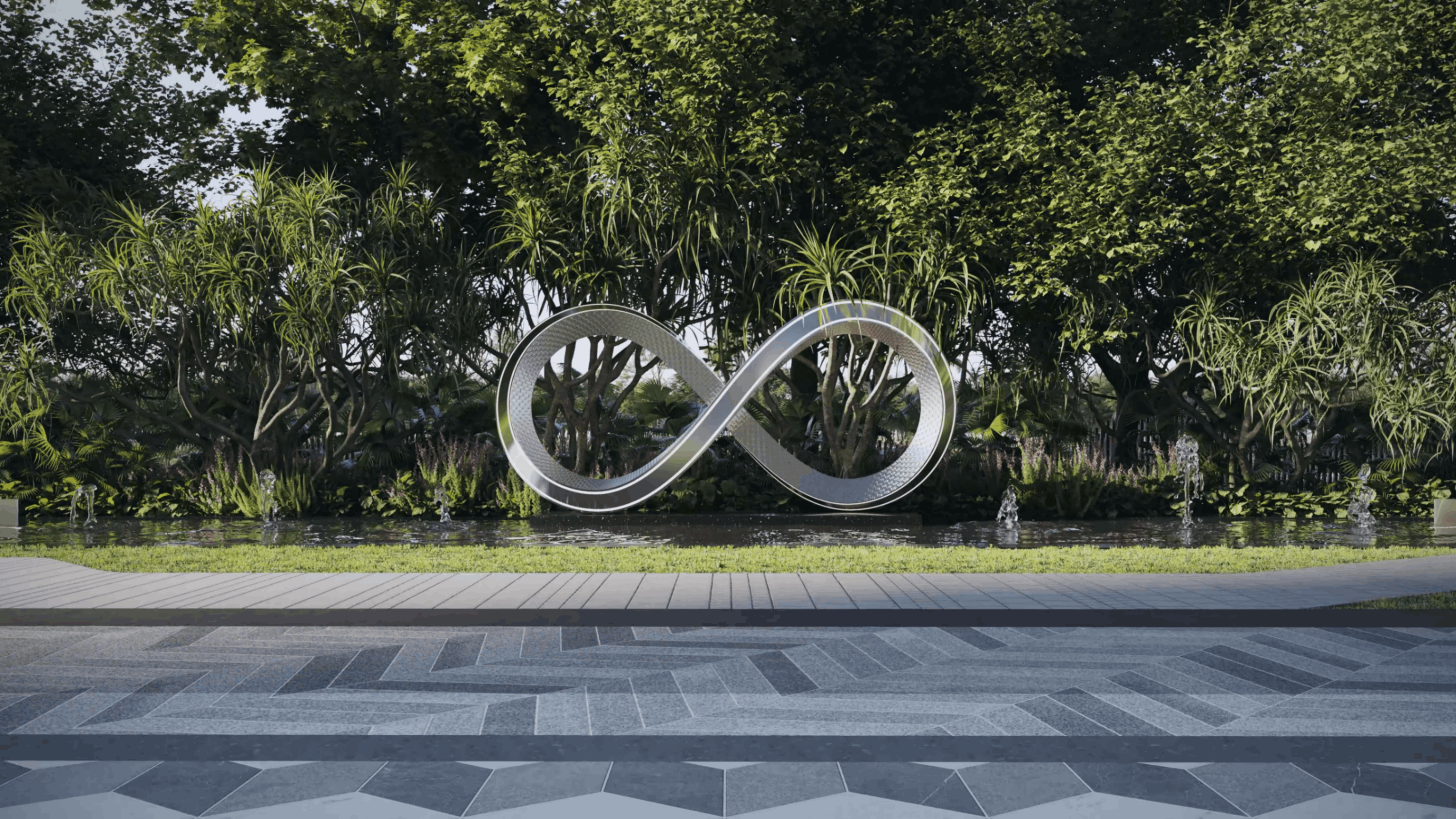Metallic infinity symbol sculpture surrounded by water fountains with lush green trees in the background.