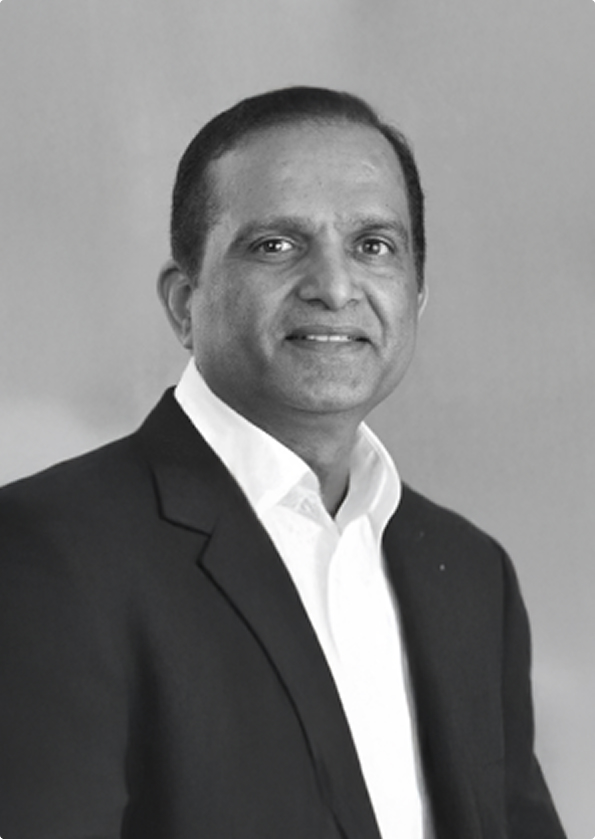 Portrait of a middle-aged man wearing a white shirt and dark suit jacket against a plain background.