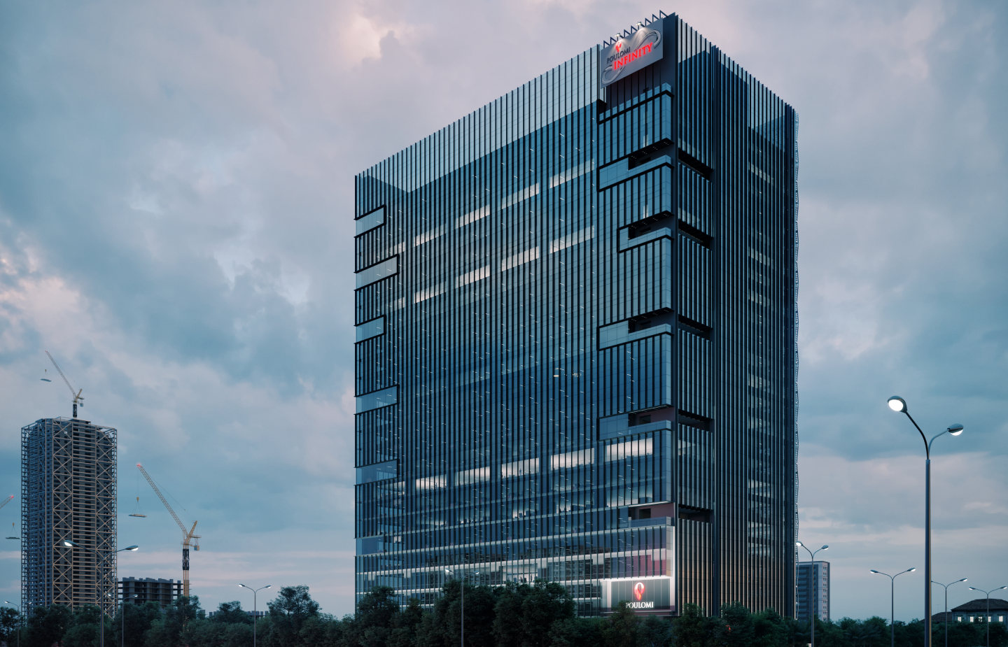 Tall modern office building with glass facade and illuminated signage reading 'POULOMI INFINITY' under a cloudy evening sky.