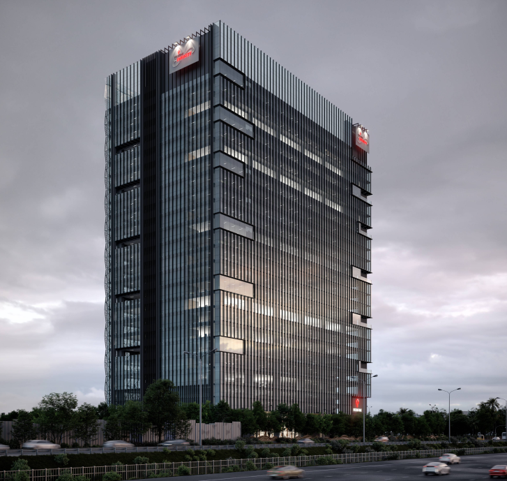 Tall modern glass office building with vertical fins and lit signs on the roof against a cloudy sky at dusk.