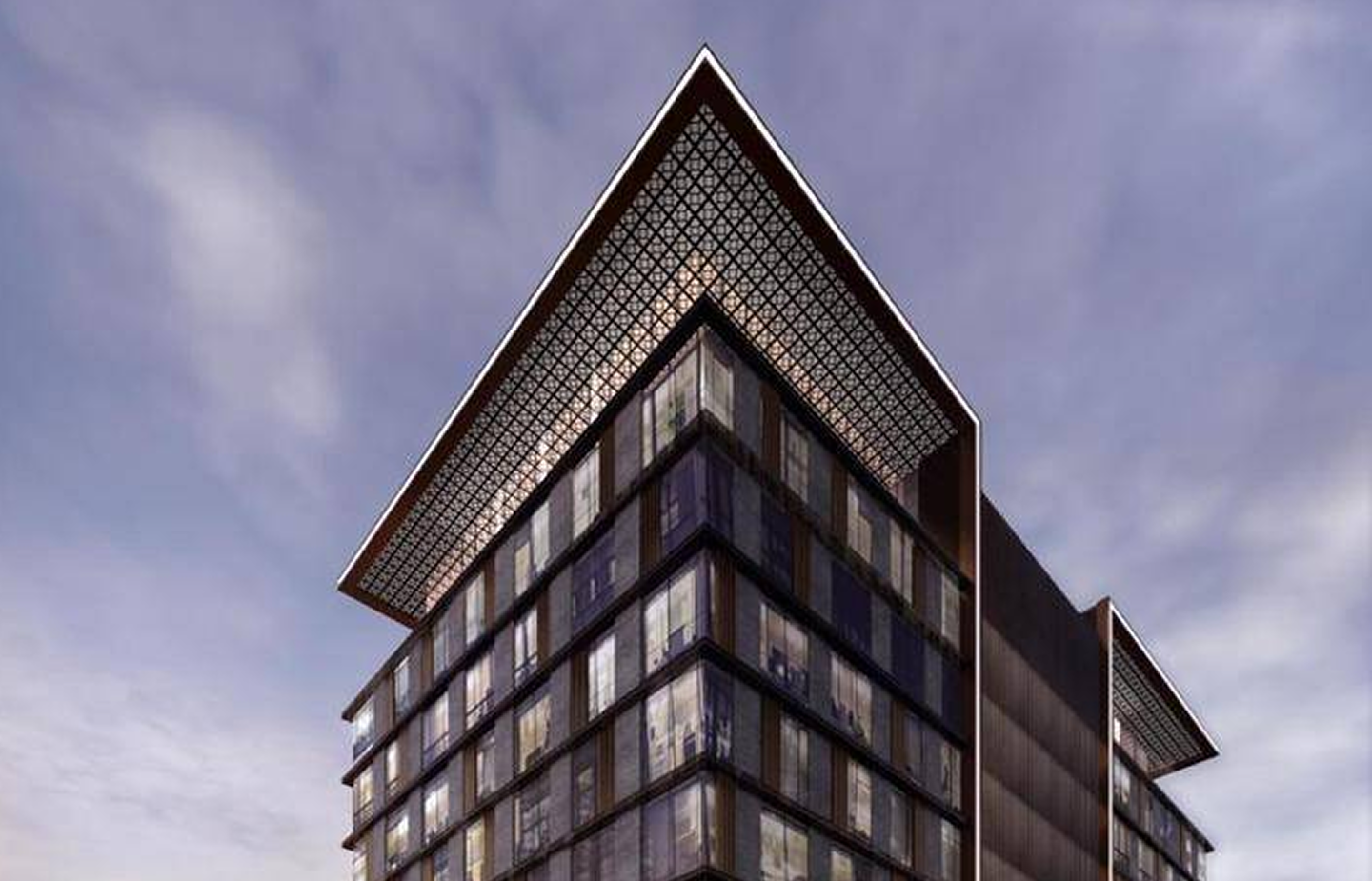 Modern glass and steel office building with a large overhanging patterned roof against a cloudy sky.
