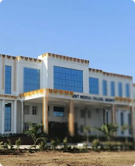 White multi-story hospital building with large windows under a clear blue sky.