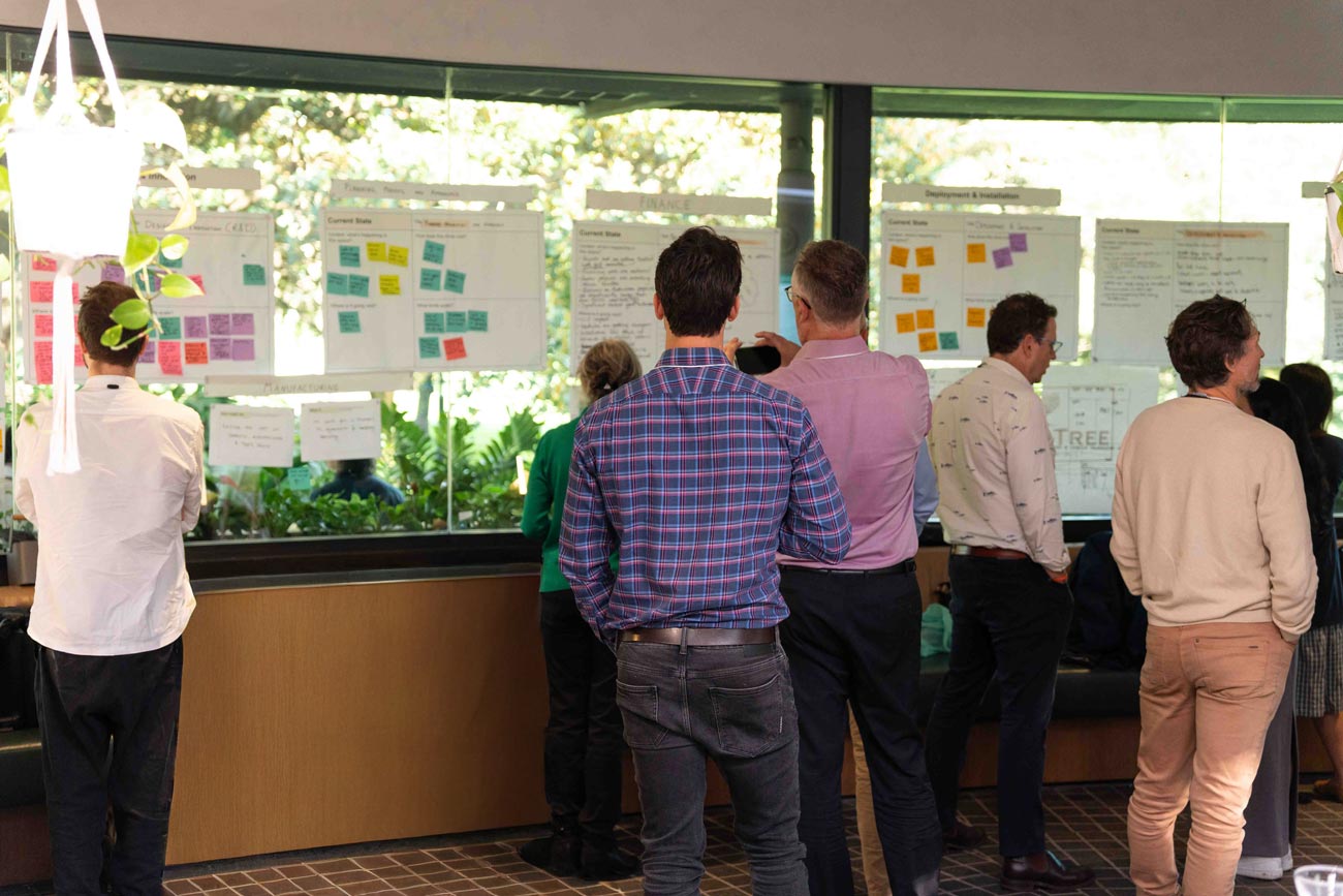 A group of people working through several challenges at an Innovation Challenge offsite.