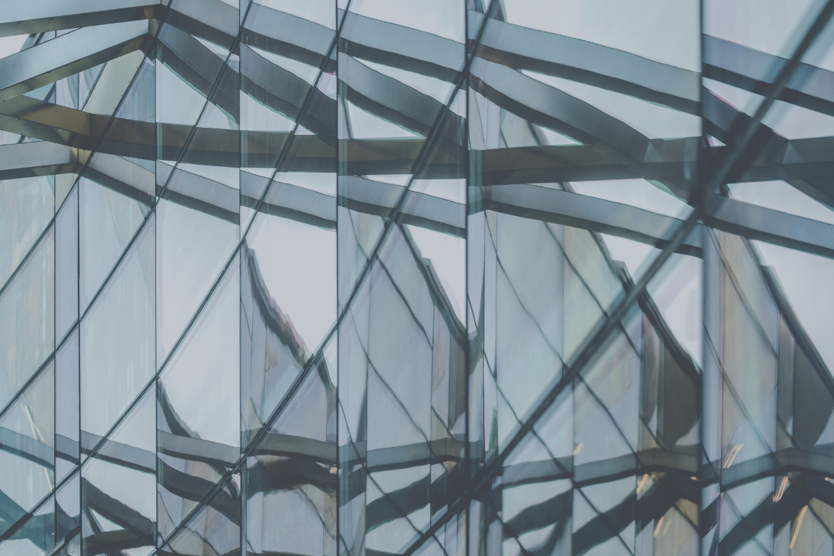 Layered glass and steel facade, representing the three regulatory regimes behind UAE mutual funds