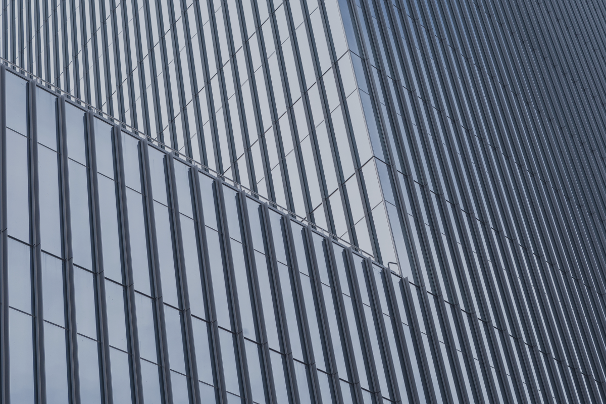 Dark glass tower with vertical fins, representing the line between discretionary and non-discretionary mandates