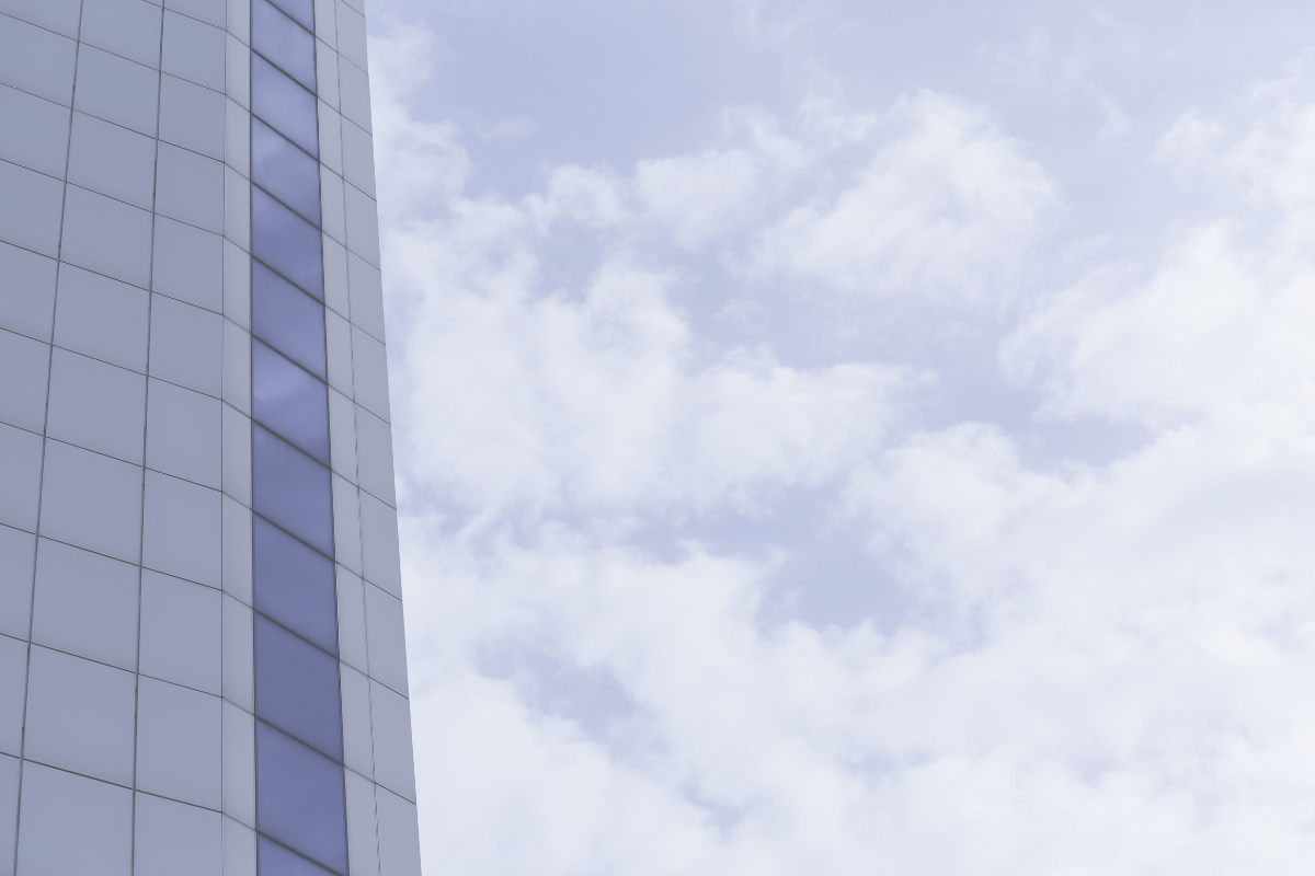 Glass tower against a cloudy sky, representing the stability of the Swiss franc