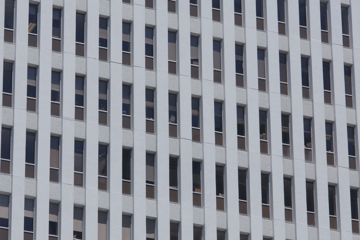 Concrete facade with a regular grid of narrow windows, representing the types of income exposed to double taxation