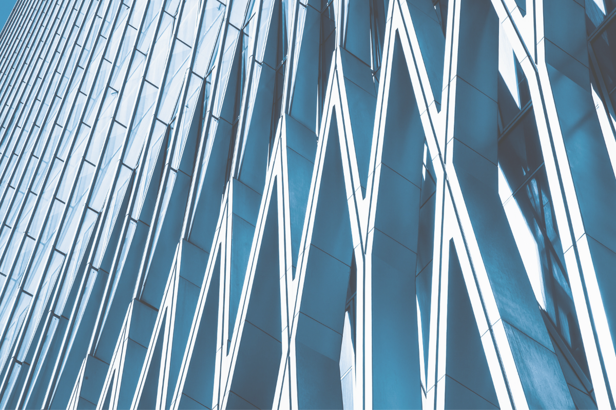 Blue glass facade crossed by diagonal white lines, representing the ordered tests of the residence tie-breaker