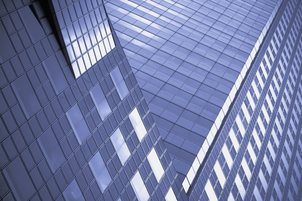Blue glass towers seen from below, representing the two tax systems that apply to a US citizen in the UK