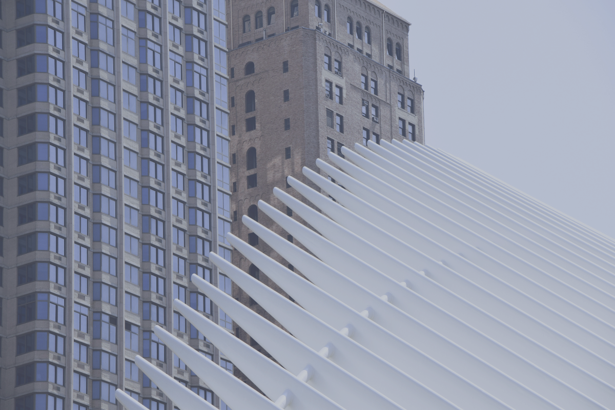 Brick tower standing beside a white ribbed structure, representing the two kinds of double taxation