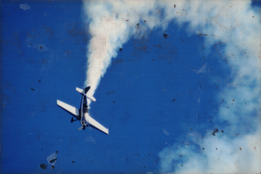 A small plane doing tricks in the sky