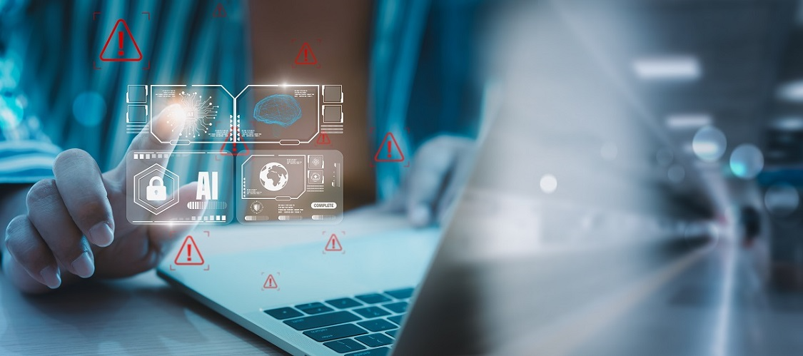 A person using a laptop with holographic AI security icons and red warning symbols, representing AI-powered threat detection and cyber risk alerts