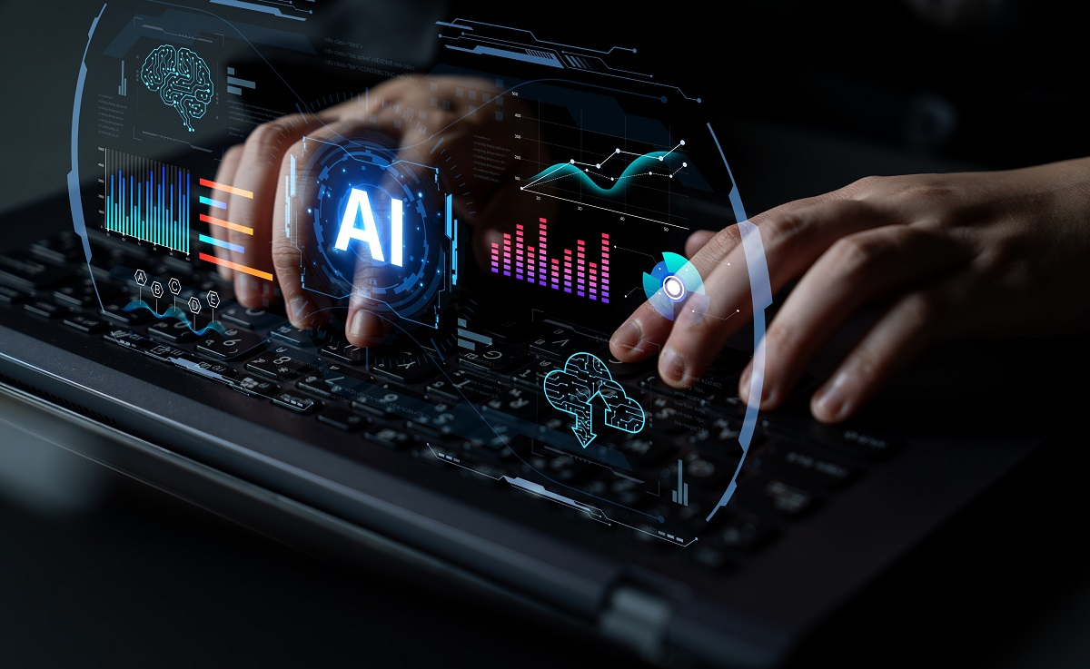 Hands typing on laptop with AI analytics dashboard and digital interface overlays representing enterprise AI security, machine learning, and cyber threat monitoring