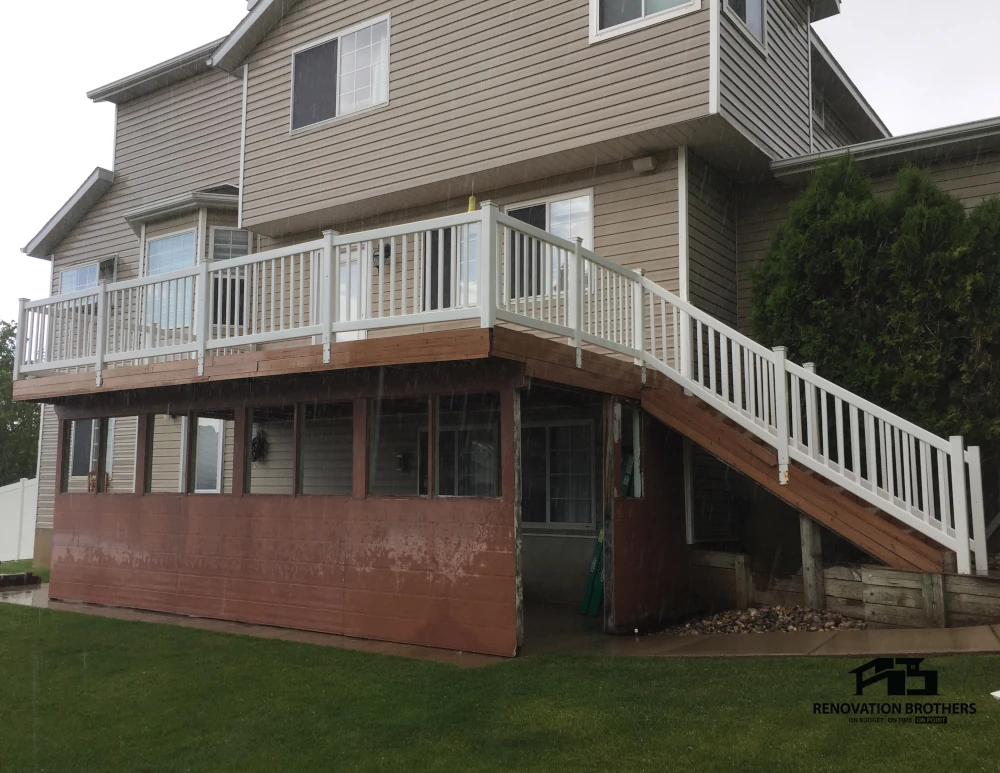 Aging deck with weathered wood skirting and stairs before an exterior remodel in Salt Lake City