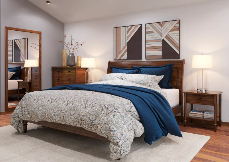 Bedroom addition with a wood sleigh bed, matching dresser and nightstands, floor mirror, and geometric wall art