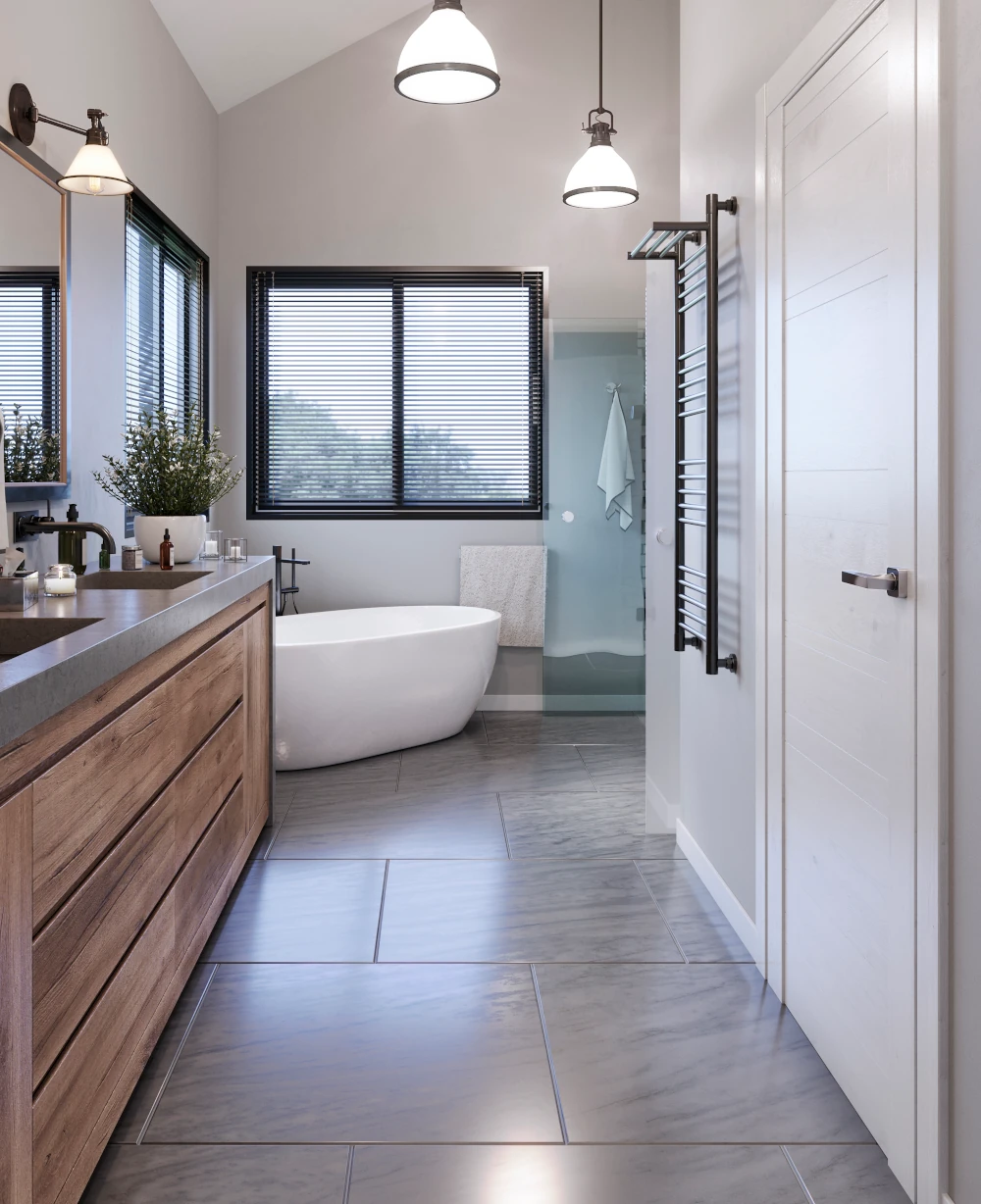Gray large-format tile flooring in a bathroom with wood vanity and freestanding tub