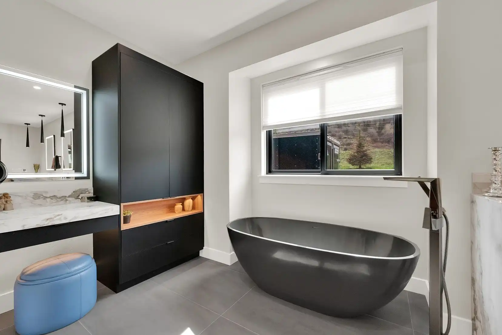 Freestanding bathtub with custom faucet and cabinetry
