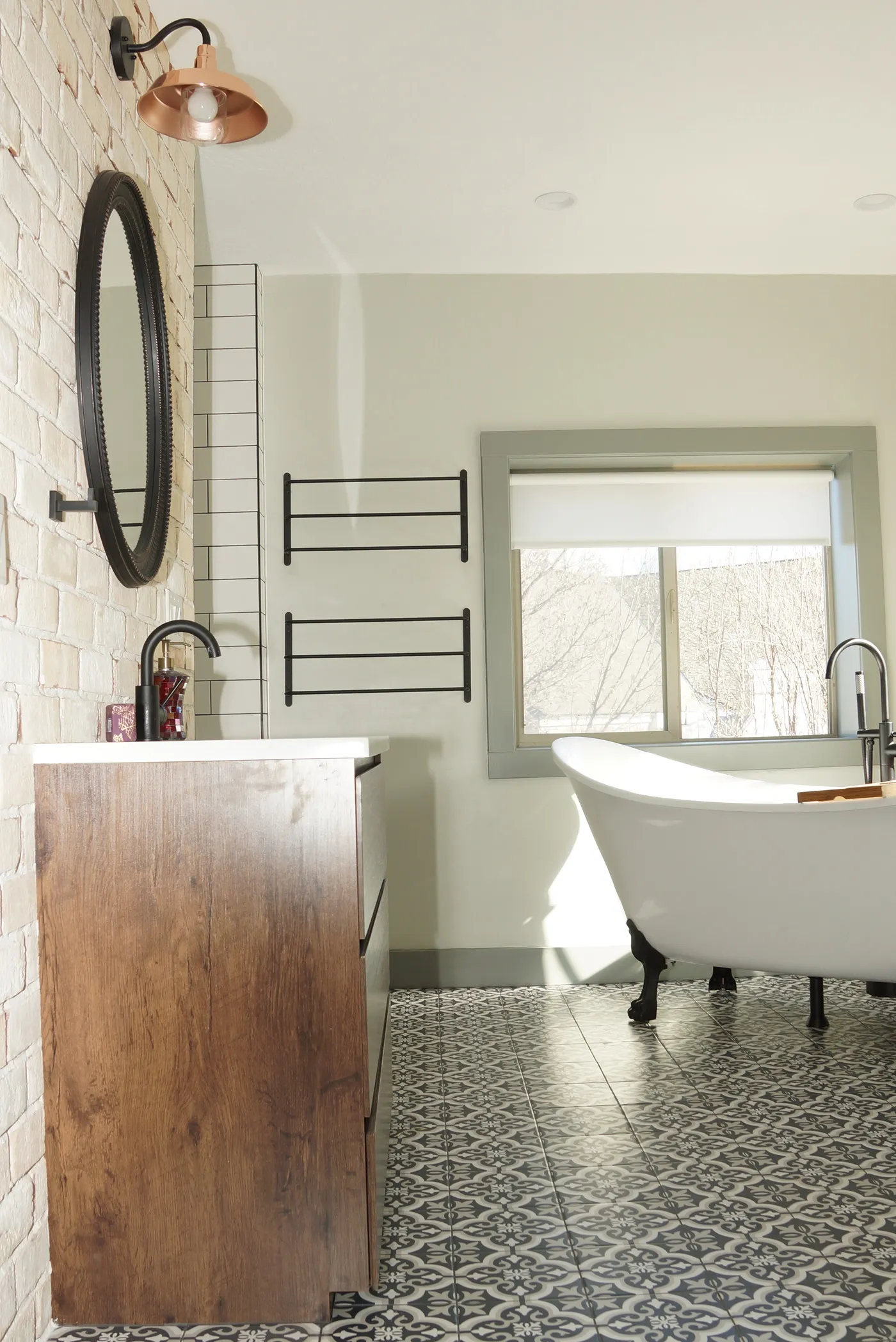 Luxury bathroom with patterned flooring and freestanding tub 