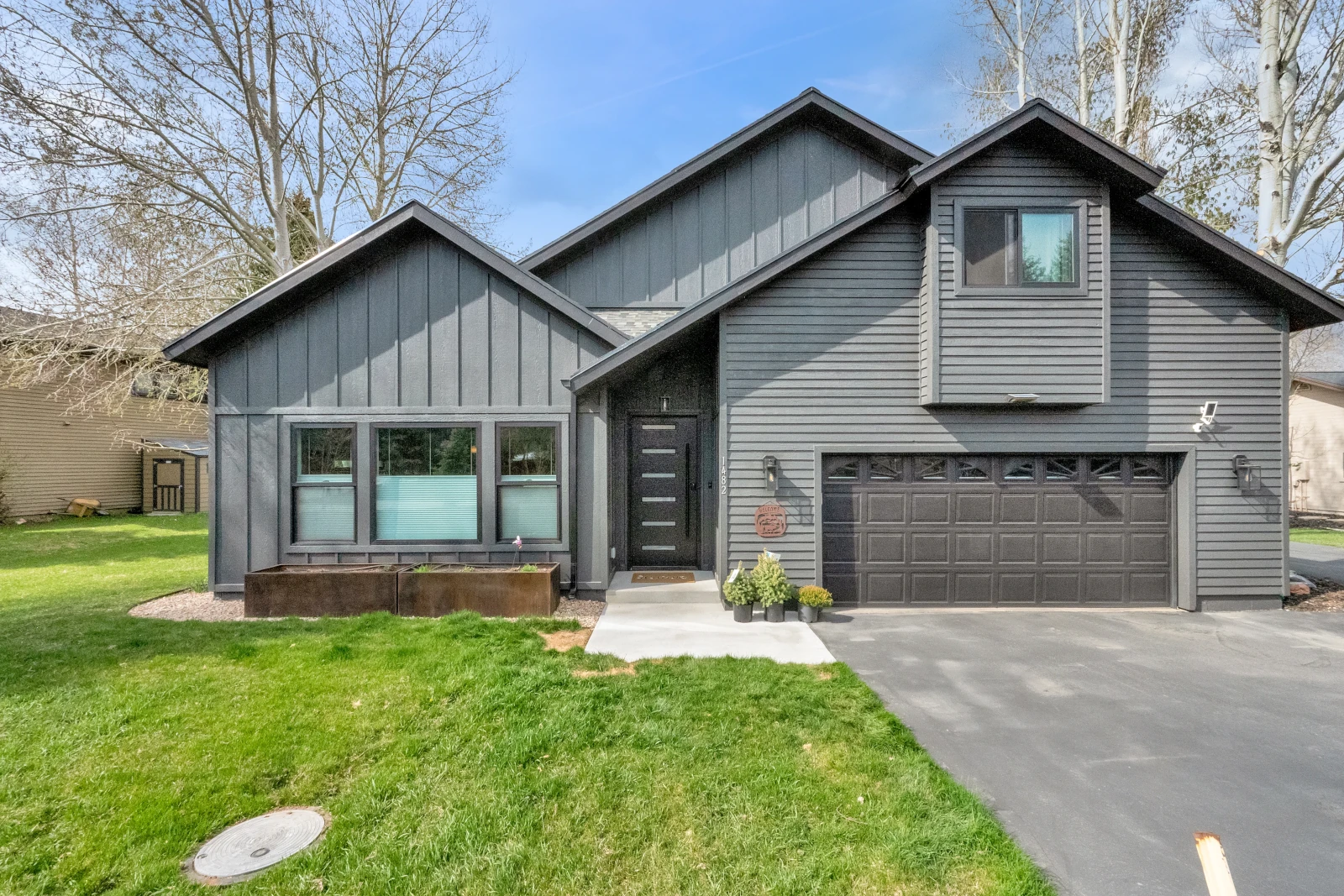 Gray board and batten home exterior with attached two-car garage