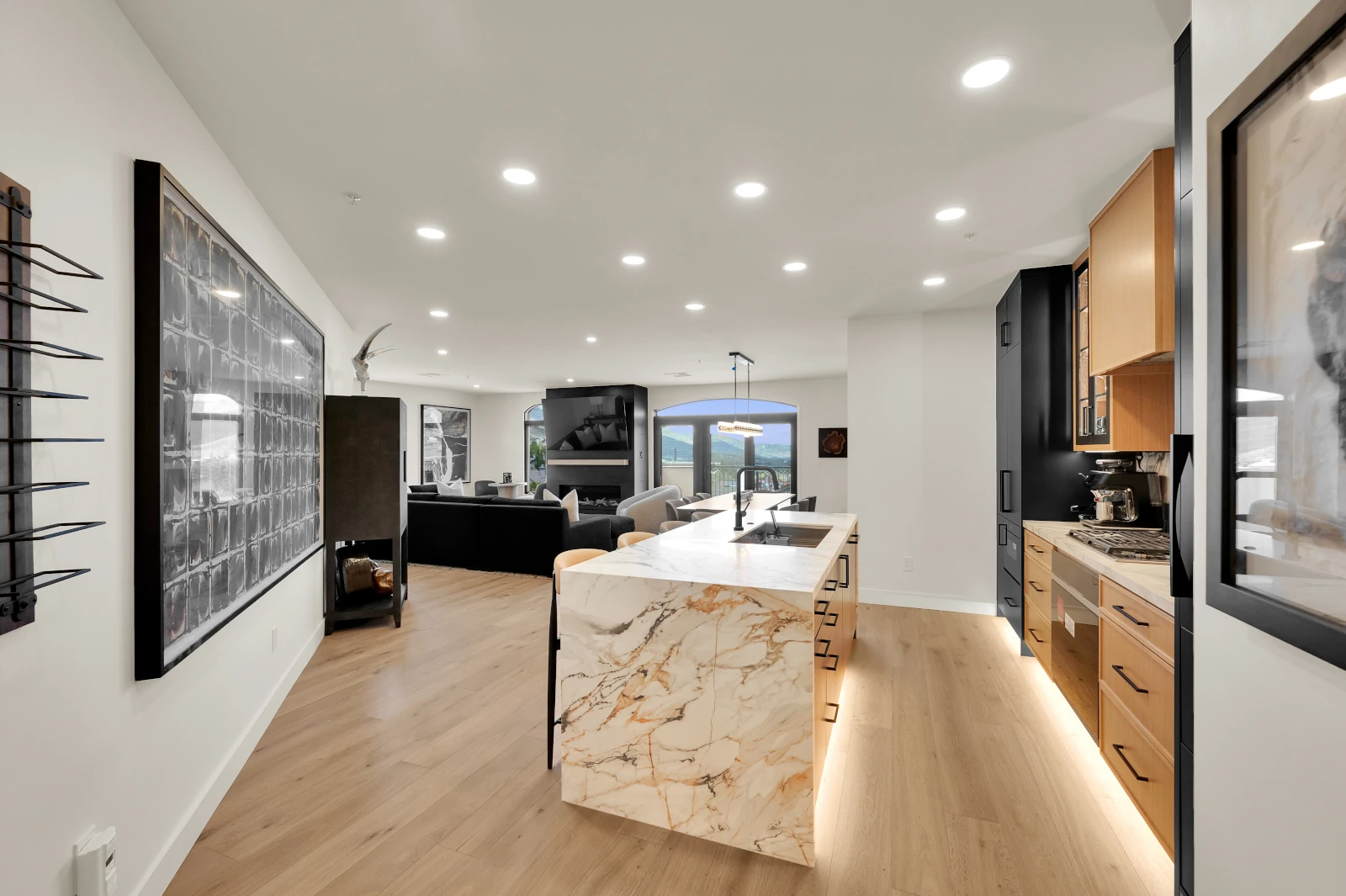 Modern kitchen remodel with marble waterfall island and white oak cabinetry