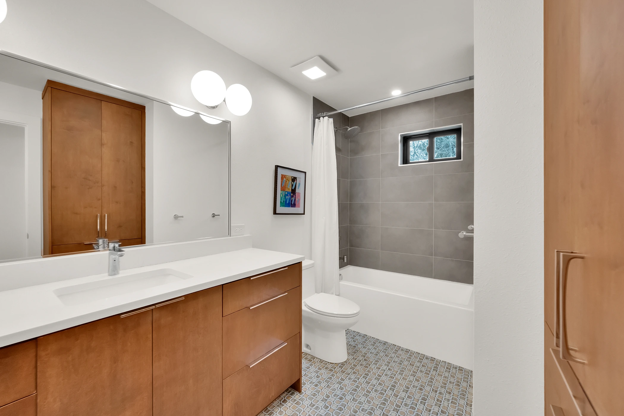 Freestanding bathtub with custom faucet and cabinetry