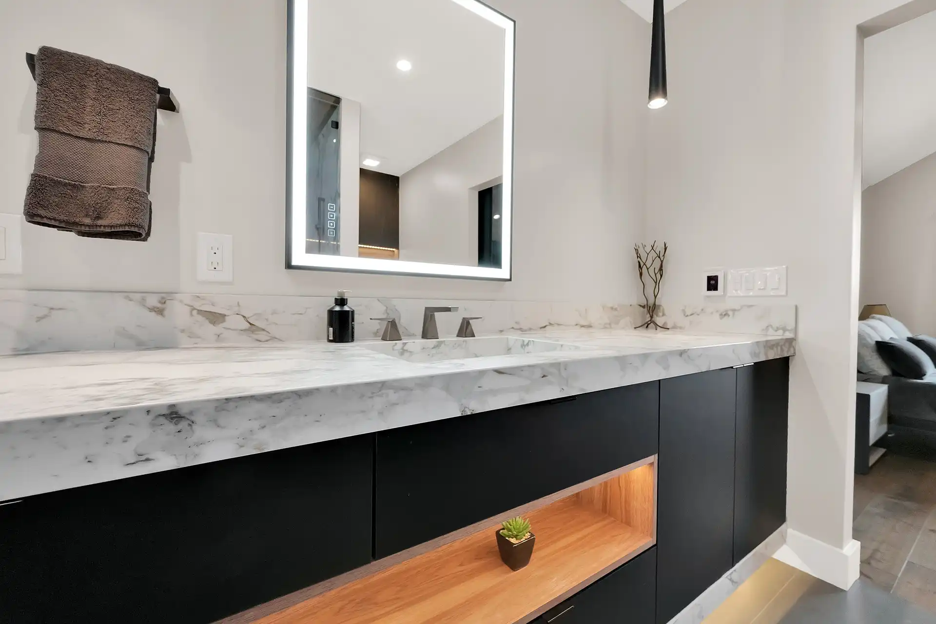 Primary suite vanity with backlit mirror in a Salt Lake City home