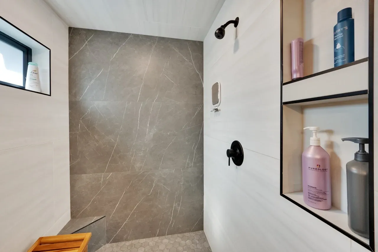 Overhead view of a toilet and large-format natural stone tile floor