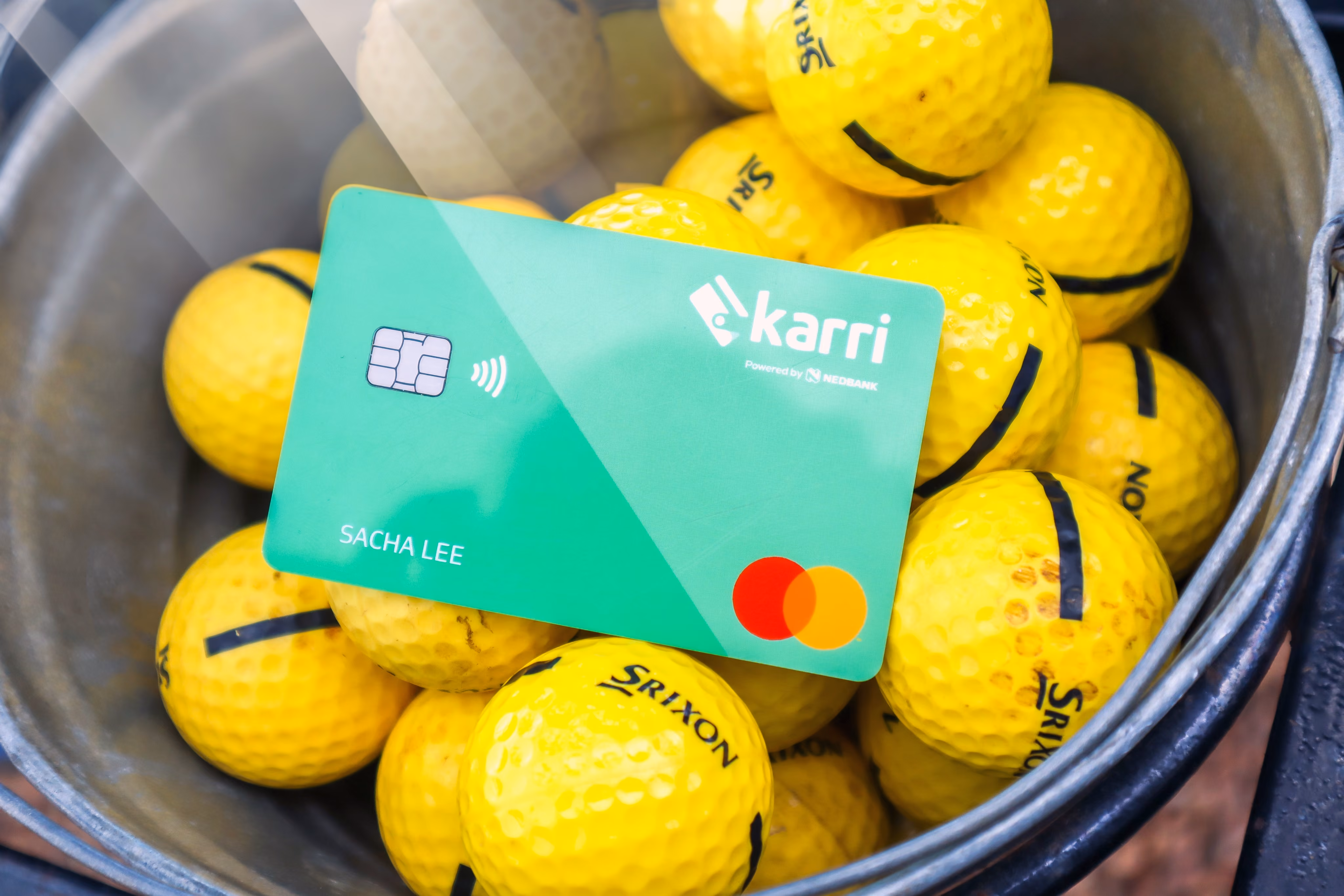 Karri Card on top of golf balls