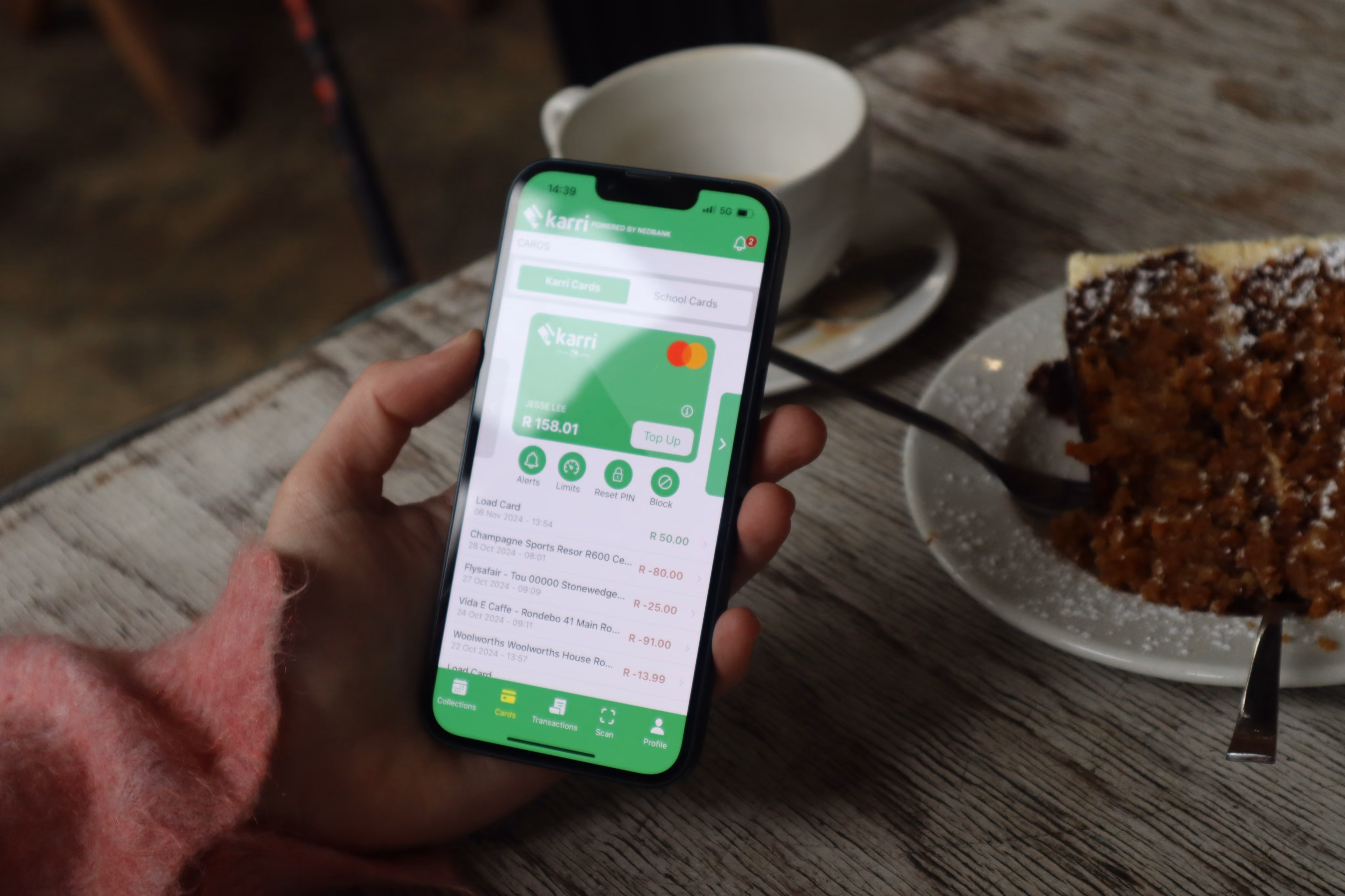 Person using Karri app on iPhone at a coffee shot