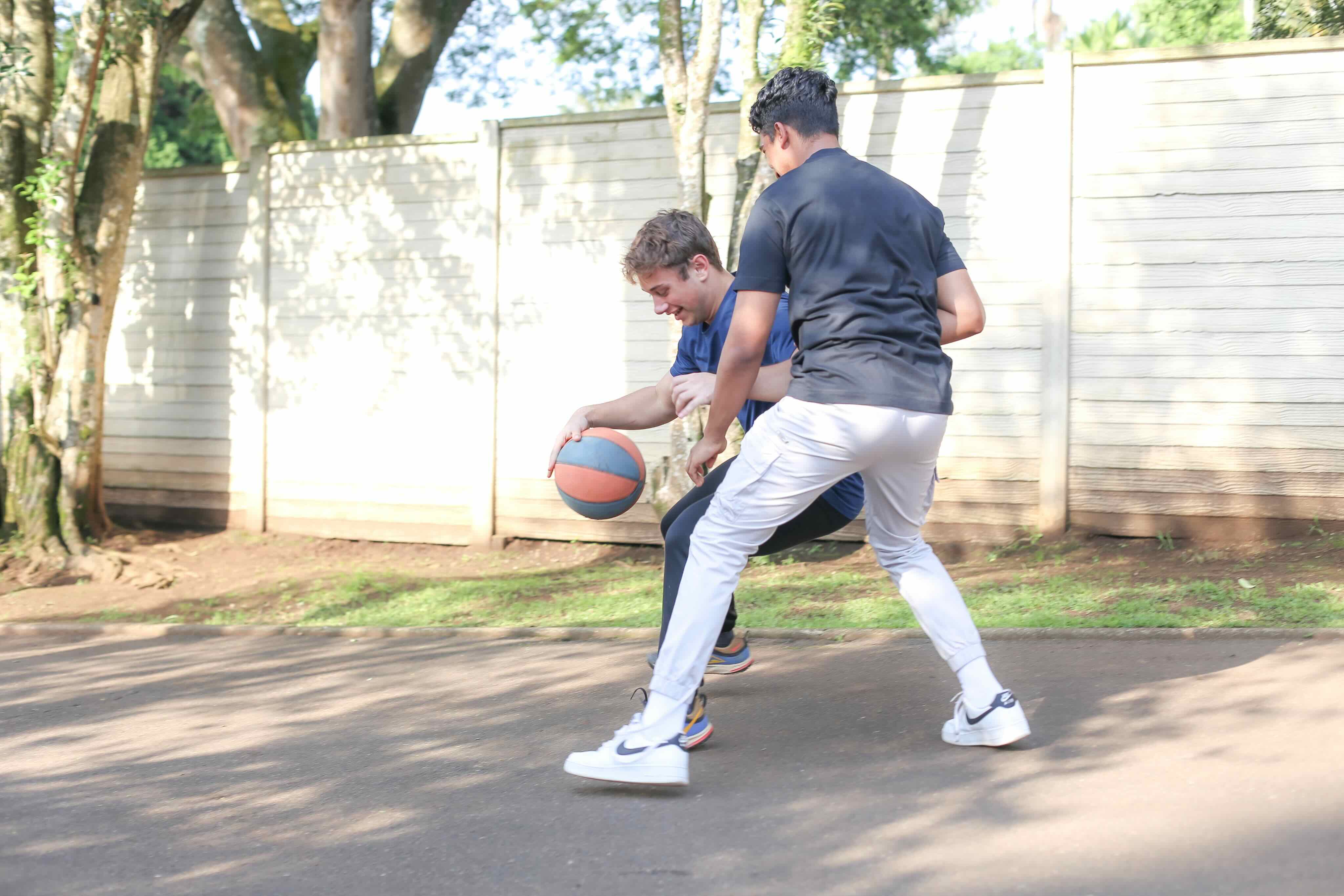2 boys playing basketball