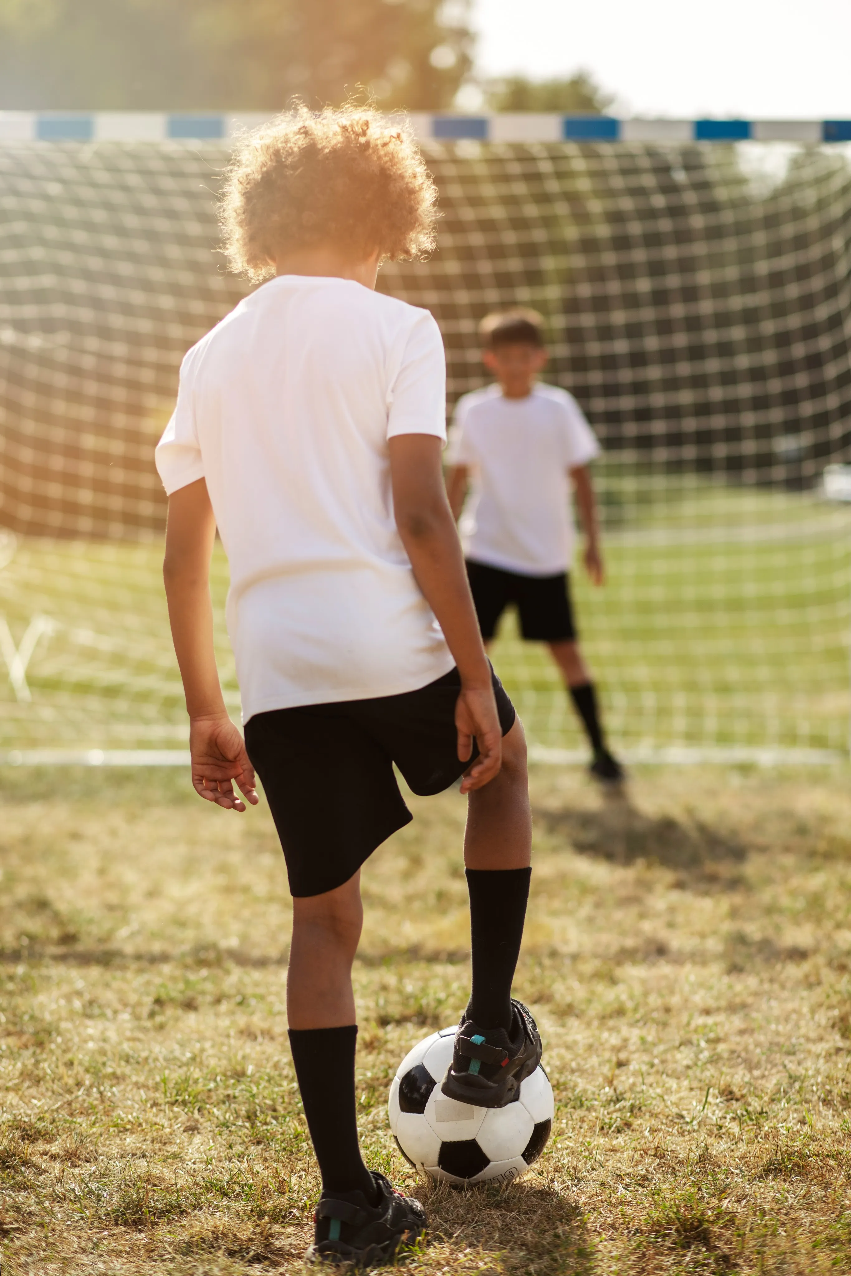 2 boys playing soccer