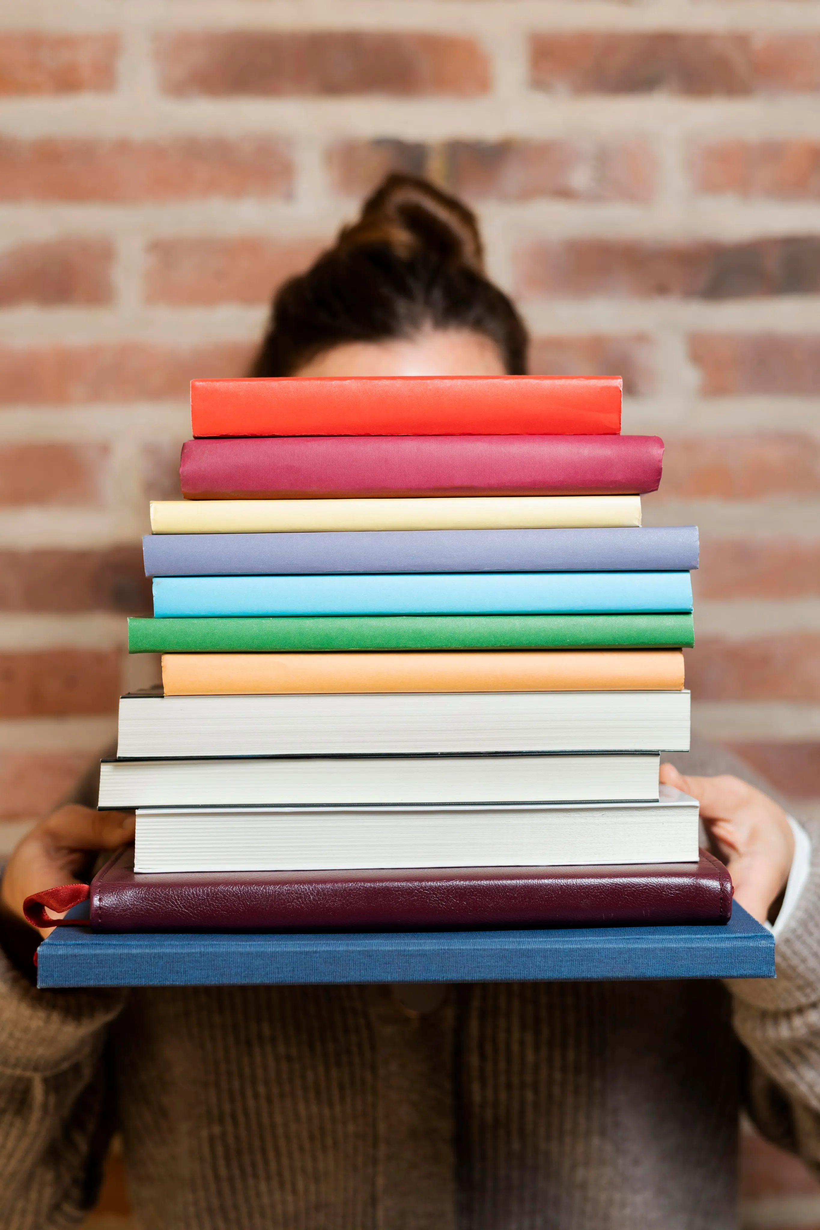 Girl holding colourful school books