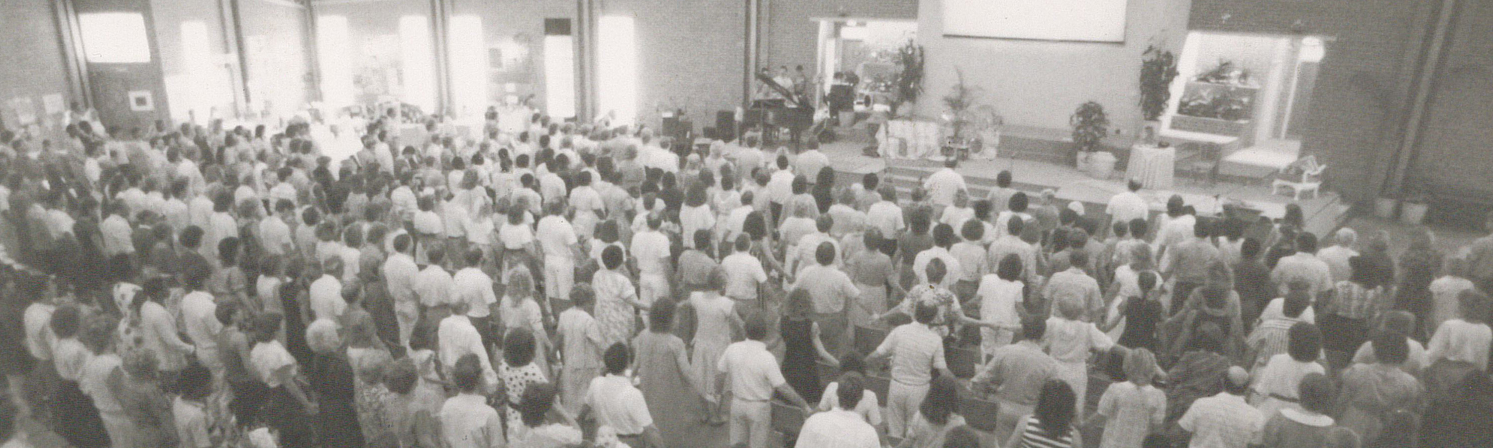 Old photo of a new covenant church bryanston church service in progress.