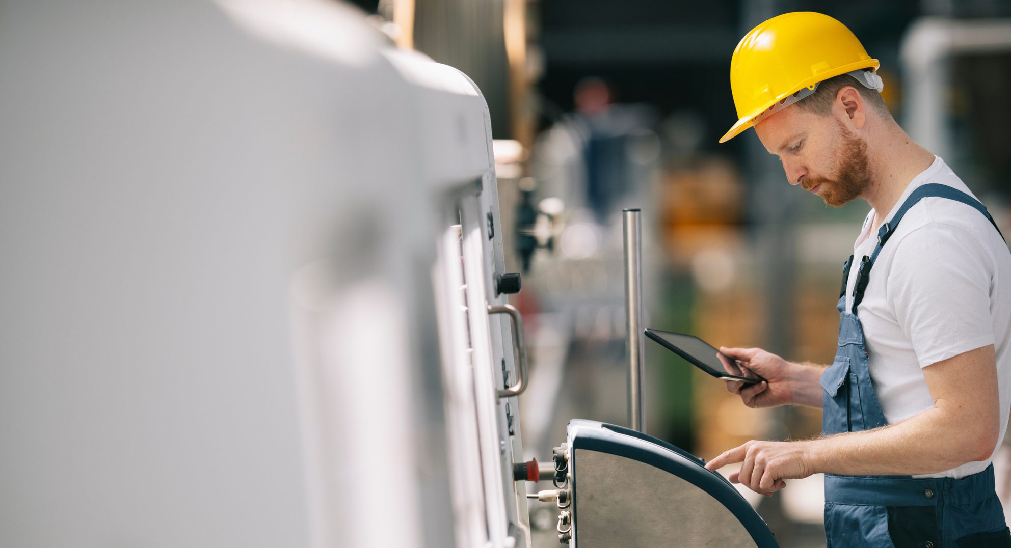 Technician checking a machine on a tablet