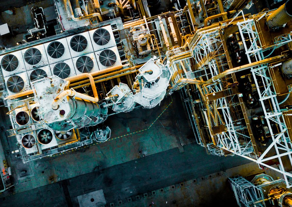 Aerial view of an energy plant with cooling fans and pipework