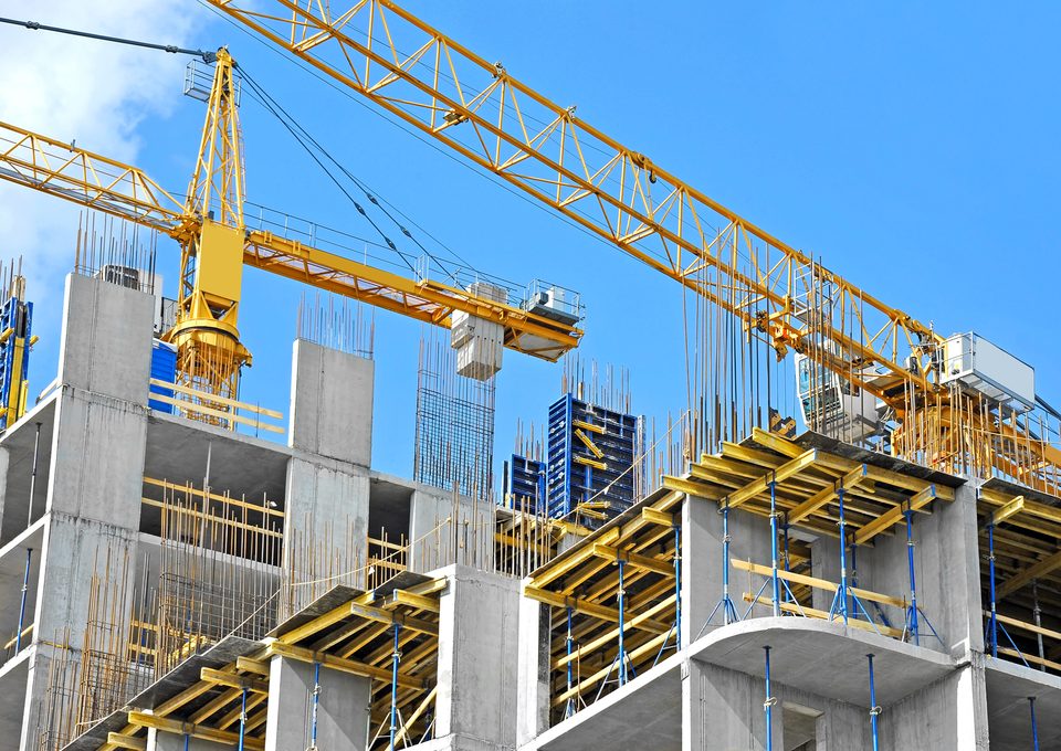 Tower crane above a concrete building under construction