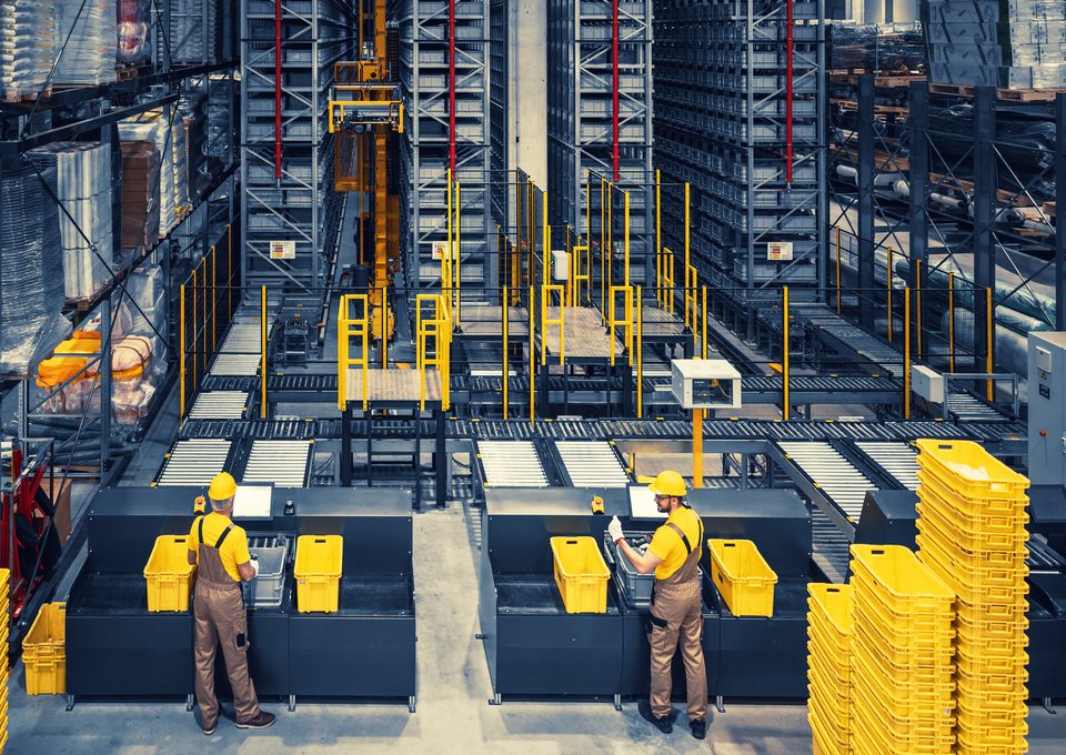 Workers at picking stations in an automated warehouse