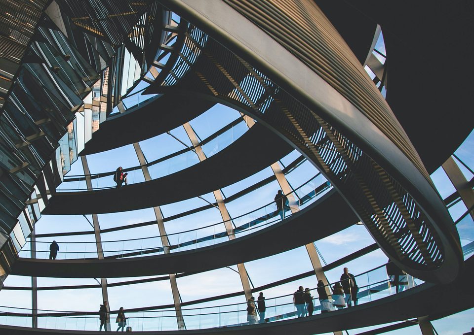 Visitors on the ramps inside a glass dome of a public building