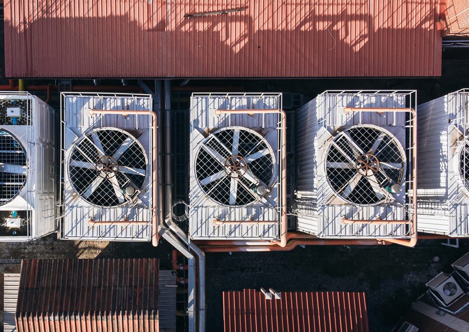 Aerial view of rooftop cooling units with large fans