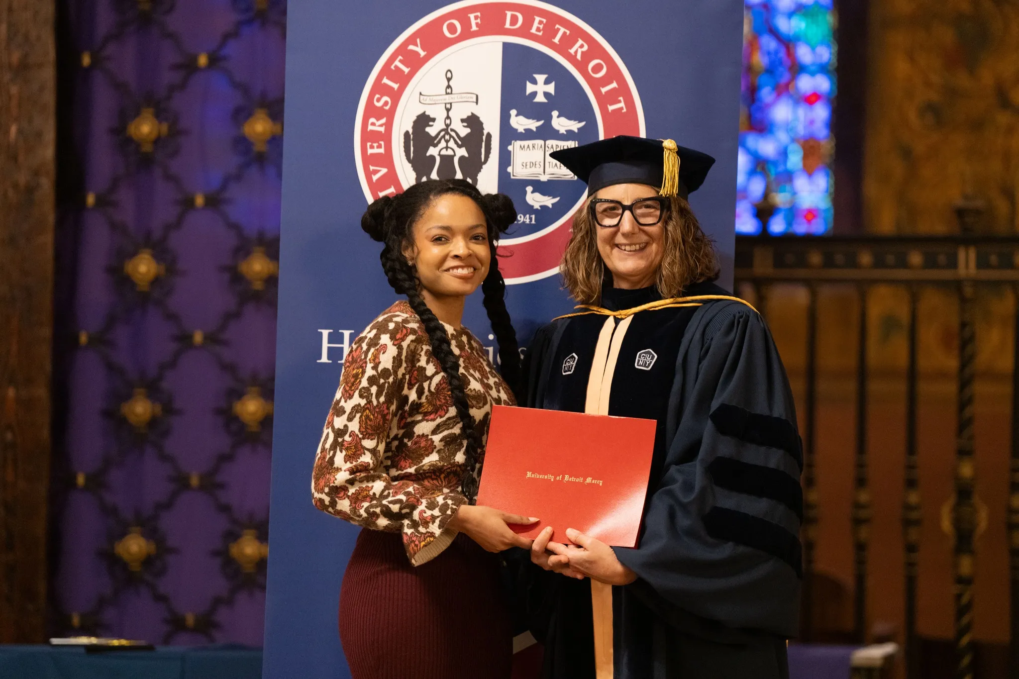 Kimmie receiving President's Golden Key award at UDM's convocation.