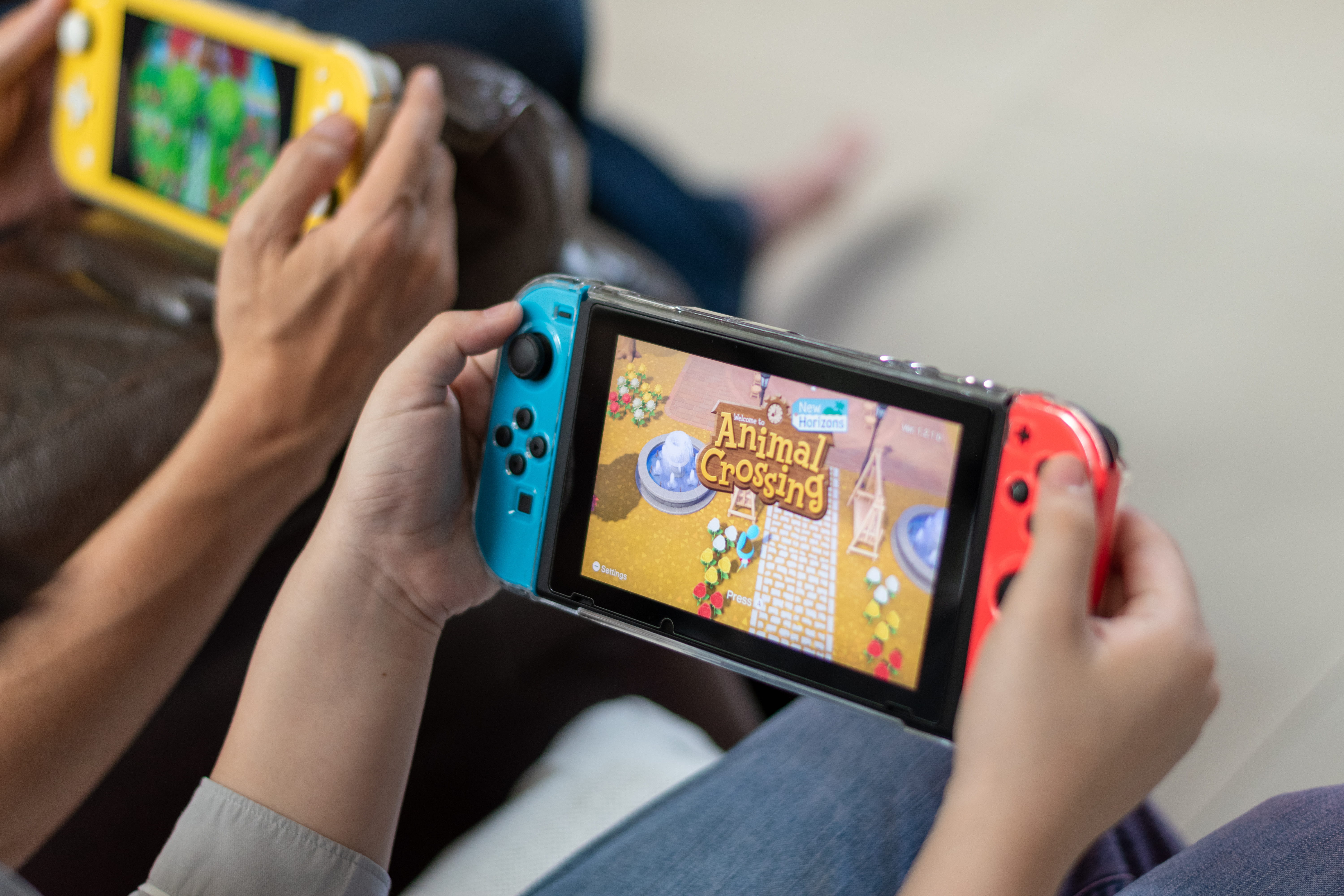 Two people playing Animal Crossing on the Nintendo Switch.