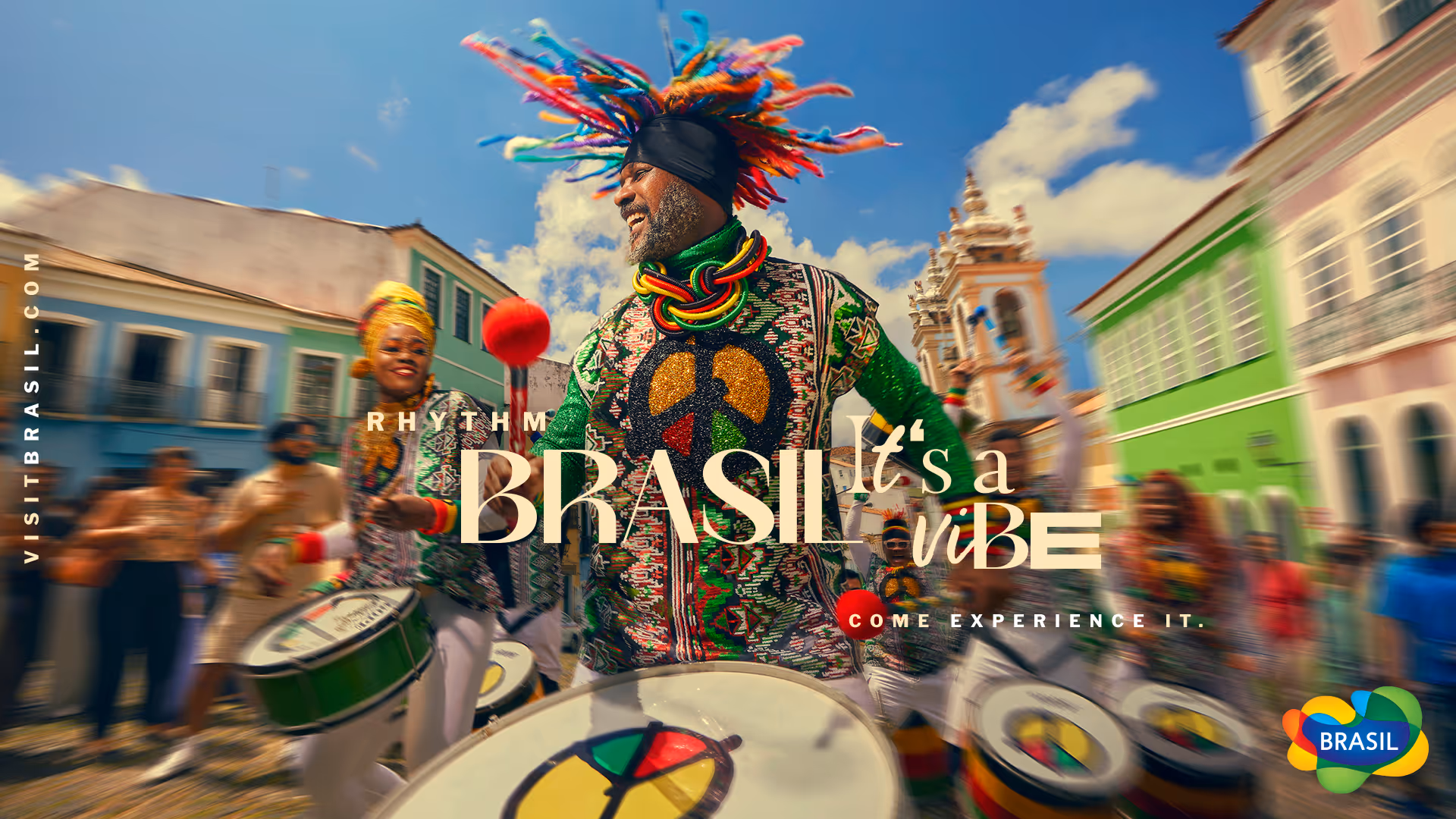 Colorful Brazilian street parade with smiling drummers in traditional attire and vibrant buildings.