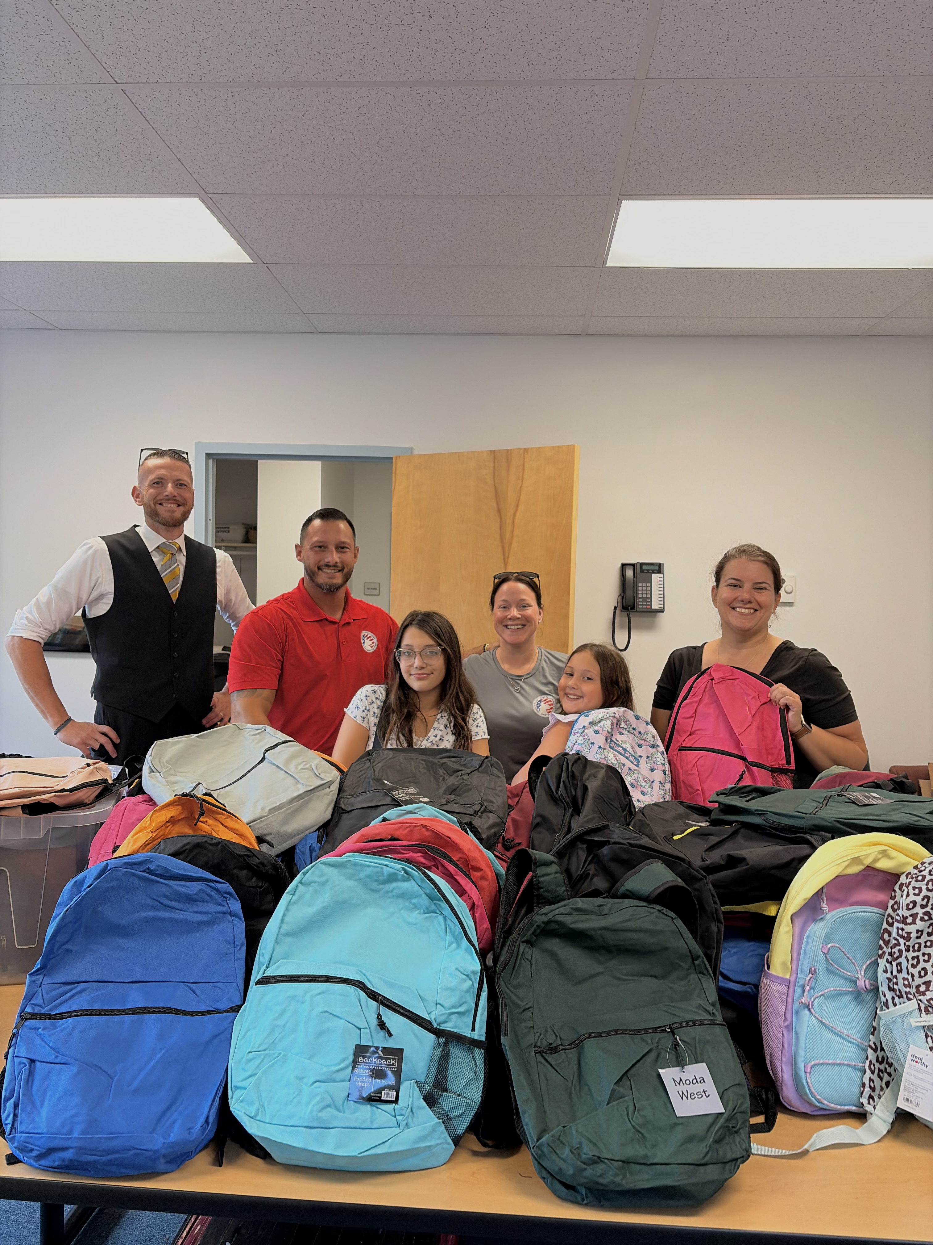 Toro Construction team and community partners with donated backpacks